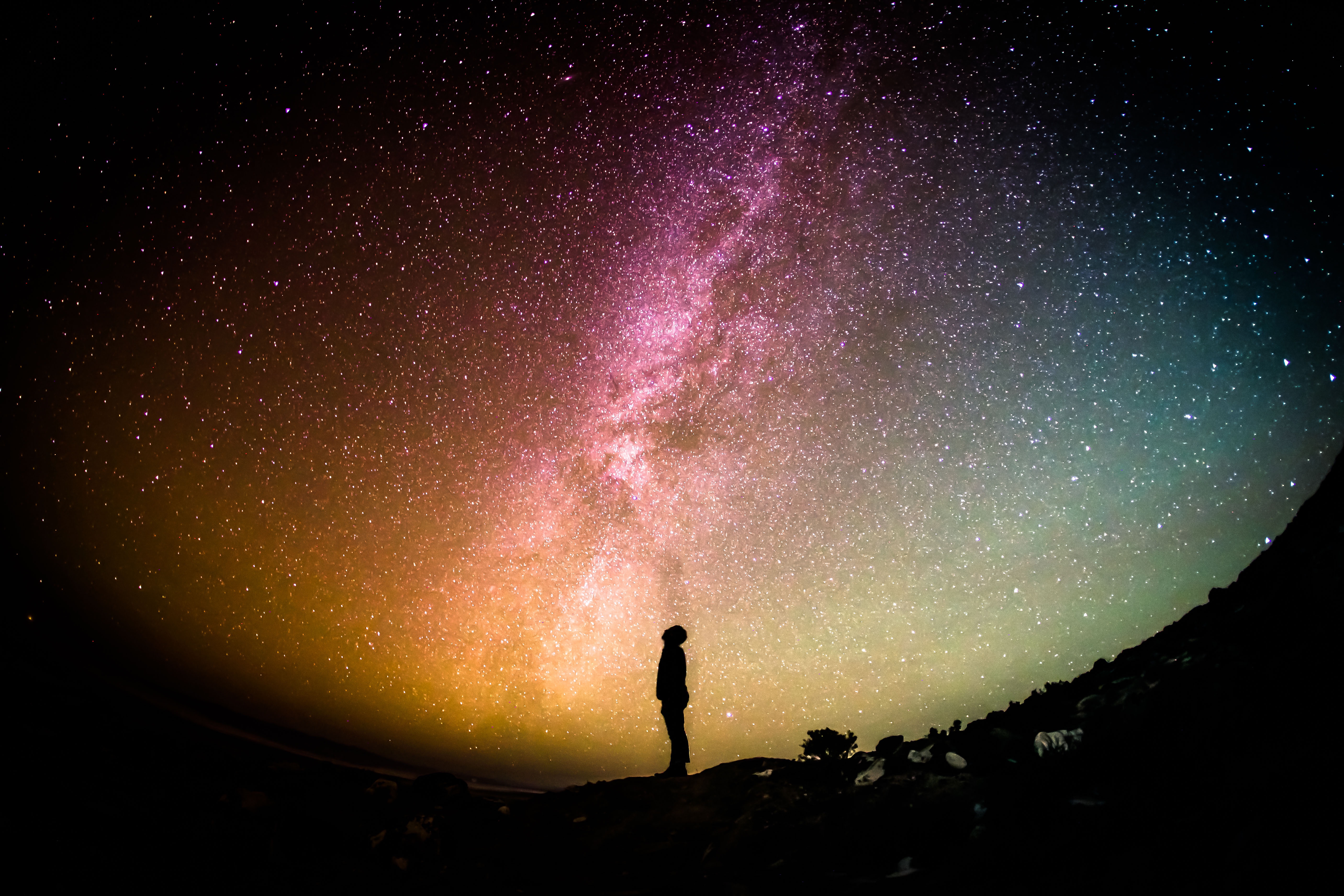 Stock image of a man looking up at a star filled sky